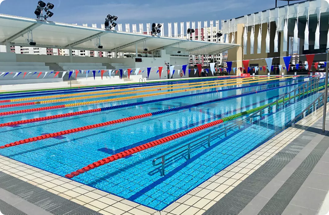 Bedok ActiveSg Public Swimming Complex with shelter, swimming lanes, sitting areas, flags and deep pool